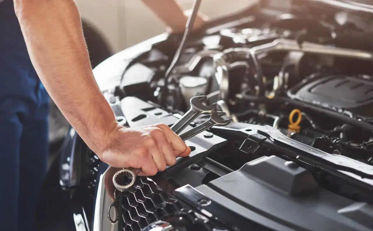 Mechanik z kluczami przy silniku. Chip tuning w silniku wolnossącym daje lepsze osiągi i moc.